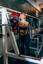 Athletic girl sets weight on barbell in the gym Royalty Free Stock Photo