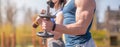 Athletic guy and girl doing exercises with dumbbells at the sports field Royalty Free Stock Photo