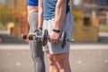 Athletic guy and girl doing exercises with dumbbells at the sports field Royalty Free Stock Photo