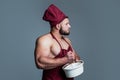 athletic guy with strong muscles in chef apron cooking food, culinary