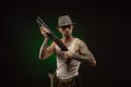 Athletic guy with a tattoo poses with a shotgun Royalty Free Stock Photo