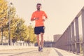 Athletic healthy runner jogging on the city street in Urban training workout Royalty Free Stock Photo