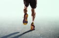 Athletic legs and running shoes of sport man jogging isolated in fitness healthy endurance concept in advertising style