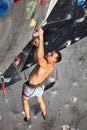 Male professional climber at indoor workout at bouldering centre. Royalty Free Stock Photo