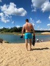 Man with snorkeling gear in hands going to sea on beach Royalty Free Stock Photo