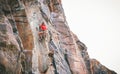 Athletic man climbing a rock wall - Climber training and performing on a canyon mountain