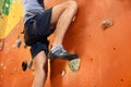 Athletic man climbing wall in gym, closeup Royalty Free Stock Photo