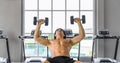 Athletic man doing dumbbell weightlifting on bench in gym and fitness