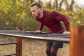 Athletic man doing pullups outdoors Royalty Free Stock Photo