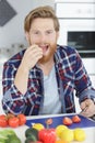 athletic man eating tomatoes at home Royalty Free Stock Photo