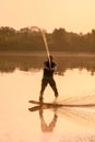 athletic man engaged in water sport and skilfully balancing on water surface on a wakeboard