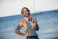 Man with fit body holding bottle of refreshing water, resting after workout or running at beach Royalty Free Stock Photo