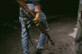 Athletic man in gray clothes with a carbine gun in his hand Royalty Free Stock Photo