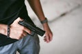 Athletic man in gray clothes with a carbine gun in his hand Royalty Free Stock Photo