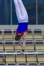 Athletic man gymnasts competing on the bar