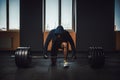 Athletic man in jacket with a hood waiting and preparing before lifting heavy barbell. fitness, sport, training, gym and lifestyle Royalty Free Stock Photo