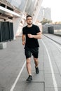 Athletic man jogging in the city. Healthy lifestyle. Man running. Urban city lifestyle. Active living. Outdoor fitness Royalty Free Stock Photo