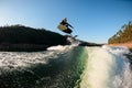 athletic man jump with foil wakeboard over splashing wave Royalty Free Stock Photo