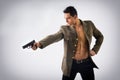 Athletic Man in Open Military Jacket Holding Gun Royalty Free Stock Photo