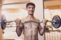 Athletic man performs workout lifting barbell