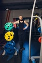 Athletic man puts on plate for barbell in the gym Royalty Free Stock Photo