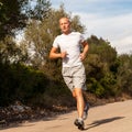 Athletic man runner jogging in nature outdoor Royalty Free Stock Photo