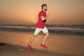 athletic man runner running on sunset summer beach, athlete Royalty Free Stock Photo