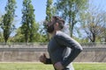 Athletic man running on a sunny morning in a green city park