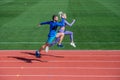 Athletic man and sexy woman compete in sprint. male and female coach on stadium running track. healthy lifestyle Royalty Free Stock Photo