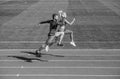 athletic man and sexy woman compete in sprint. male and female coach on stadium running track. healthy lifestyle Royalty Free Stock Photo