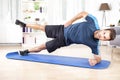 Athletic Man in Side Planking with One Leg Raised