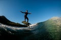 athletic man skillfully balances on wave on a foil wakeboard Royalty Free Stock Photo