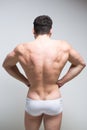 Athletic man turned back on white background. Royalty Free Stock Photo