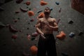 Athletic man using chalk before climbing in a bouldering gym