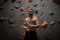 Athletic man using chalk before climbing in a bouldering gym