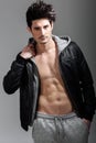 Athletic man wearing hoodie jacket. Studio shot