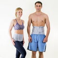 Athletic Man and Woman Wearing Back Support Braces