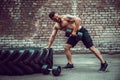 Athletic man working out with a dumbbell. Strength and motivation. Exercise for the muscles of the back