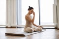 Athletic mature caucasian women in sports clothes breathing in asana position.