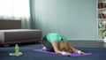 Athletic mature woman practicing yoga poses home, fitness and health, stretching Royalty Free Stock Photo