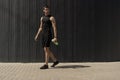 Athletic modern young man posing on a gray metallic wall copy sp