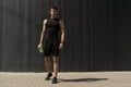 Athletic modern young man posing on a gray metallic wall copy sp