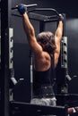 Athletic muscular man doing pull-ups in a gym Royalty Free Stock Photo