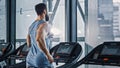 Athletic Muscular Man Running on a Treadmill, Leg and Cardio Day. Strong Man Training in the Modern Royalty Free Stock Photo