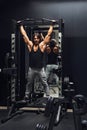 Athletic muscular man doing pull-ups in a gym Royalty Free Stock Photo