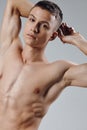 athletic physique young male nude torso gray background portrait Royalty Free Stock Photo