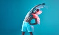 Athletic, pumped-up man leans to the right. A young man with a bare torso and white shorts on a blue background.