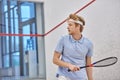 athletic redhead sportsman holding racquet while