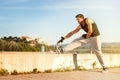 Athletic runner doing stretching exercise