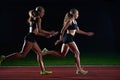 Athletic runners passing baton in relay race Royalty Free Stock Photo